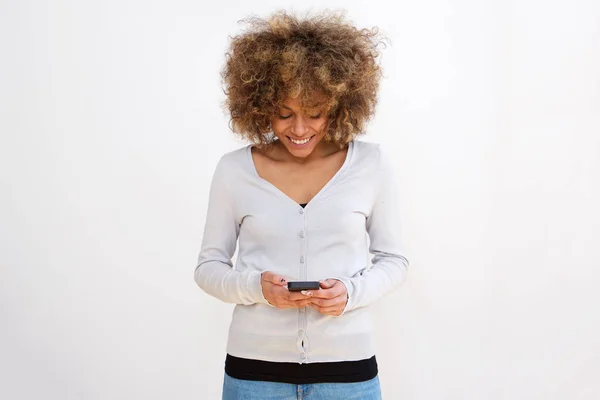 Portrait of young woman looking at text message on cellphone
