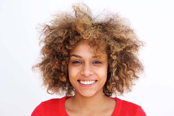 Close up portrait of beautiful young black woman with curly hair against gray background
