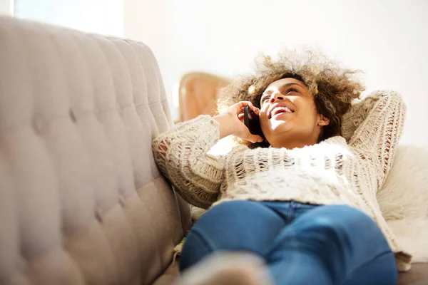 Portrait Happy Young Black Woman Lying Sofa Talking Mobile Phone — Stock Photo, Image