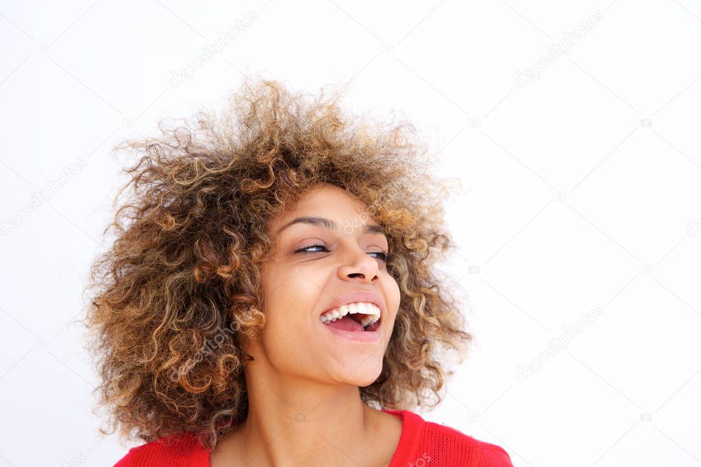 Close up portrait of beautiful black young woman with curly hair laughing