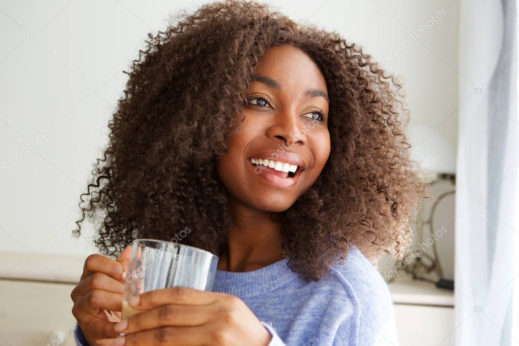 Close up portrait of beautiful young african american woman drinking cup of tea