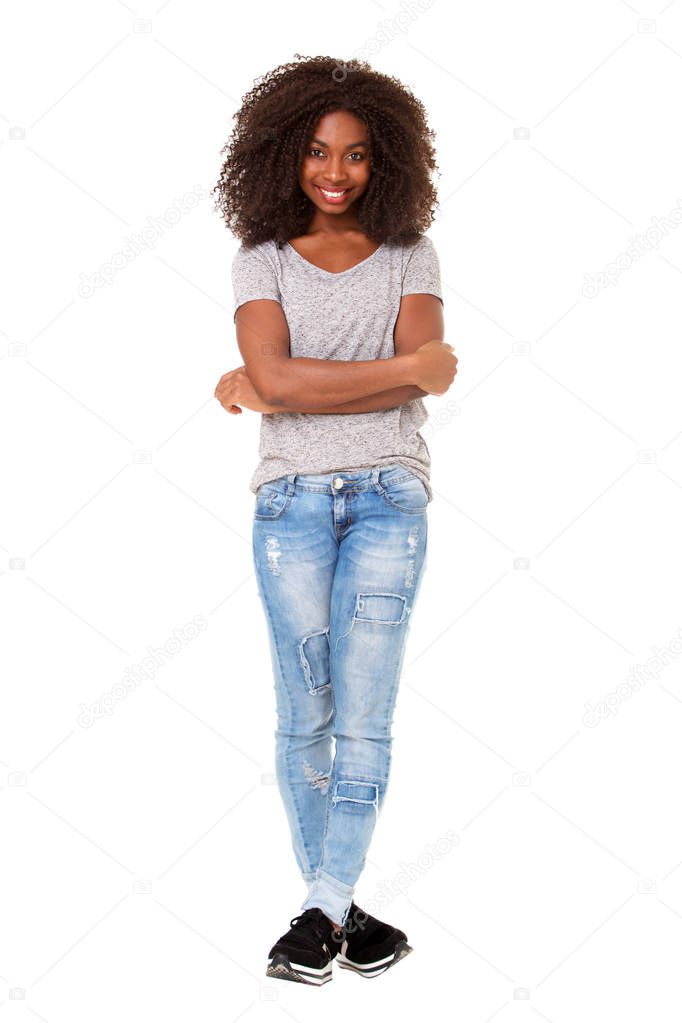 Full length portrait of beautiful young african american woman standing with her arms crossed on white background