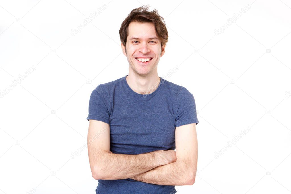 Portrait of confident man standing with arms crossed by white background
