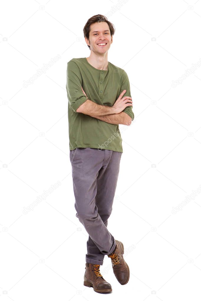 Full length portrait of casual man smiling and standing with arms crossed