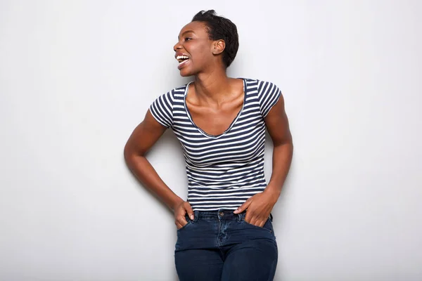 Portrait of happy african american woman laughing against gray background