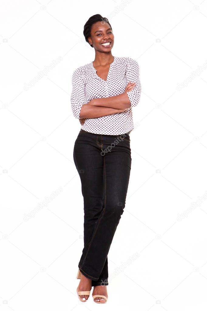 Full length portrait of beautiful young black woman standing with arms crossed