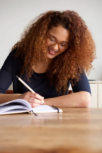 Portrait Happy Young Woman Glasses Writing Book — Stock Photo, Image