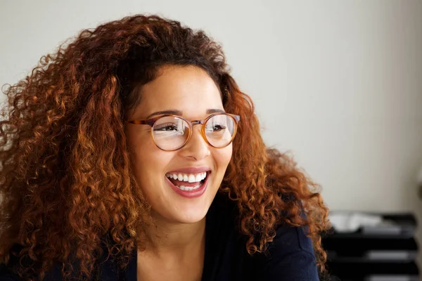 Gülüyor ve uzağa arıyorsunuz gözlüklü genç kadın portresi