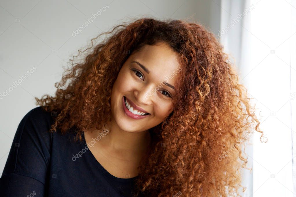 Close up portrait of beautiful young black woman with curly hair