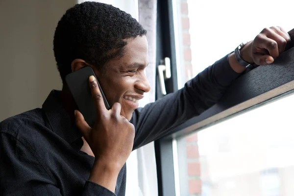 Portrait African Man Looking Out Window Talking Mobile Phone — Stock Photo, Image