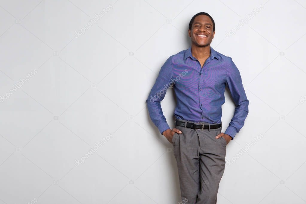 Portrait of african american businessman smiling against white background