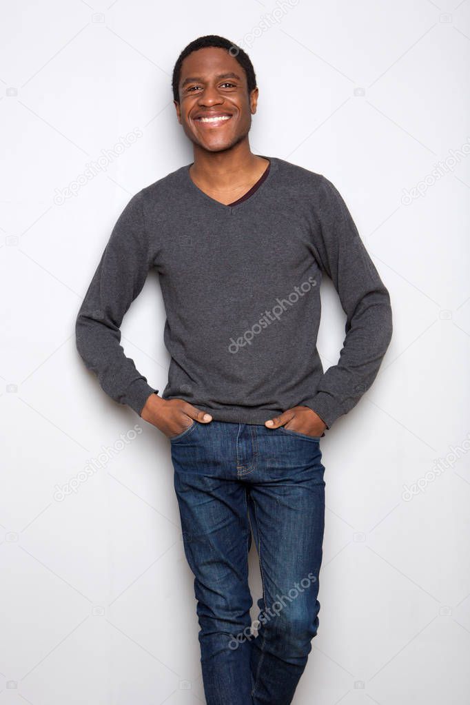 Portrait of handsome young african american man standing against white background