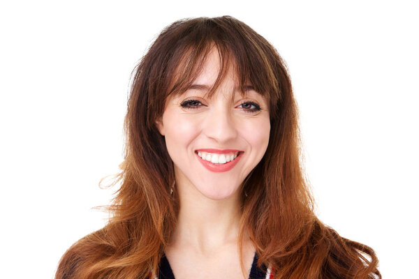 Close up front portrait of smiling young woman against isolated white background