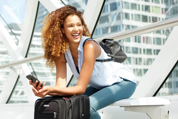 Portrait Young Woman Laughing Mobile Phone Bags Station — Stock Photo, Image