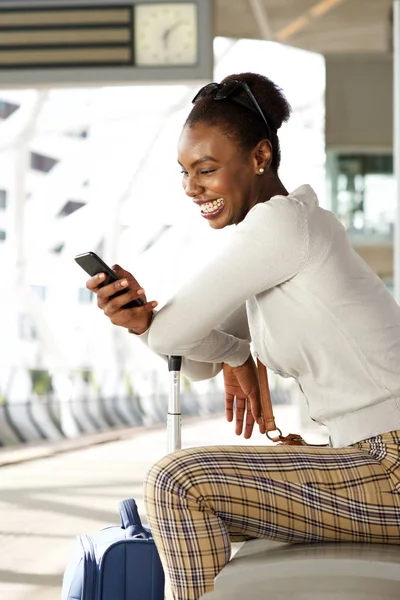 Portrait Smiling African American Woman Sitting Train Station Looking Cellphone — Stock Photo, Image