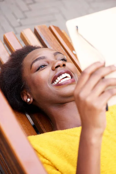 Portrait from above of happy african american woman reading book