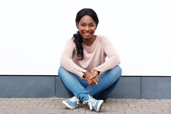 Retrato Una Atractiva Joven Negra Sentada Suelo Sonriendo Contra Pared — Foto de Stock