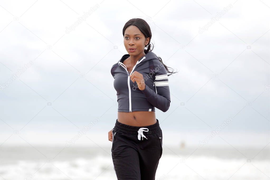 Portrait of young black woman jogging outdoors