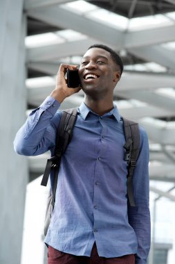 Yürüyüş ve cep telefonu ile konuşmak mutlu Afrika kökenli Amerikalı adam portresi 