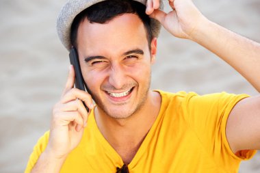 Telefonda konuşurken şapka ile mutlu bir adam portresi kadar yakın 