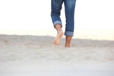 Erkek çıplak ayakla kum plaj üzerinde yürüme düşük açılı