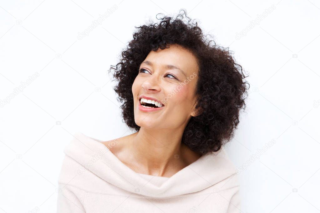 Close up portrait of attractive middle age african american woman laughing against white background