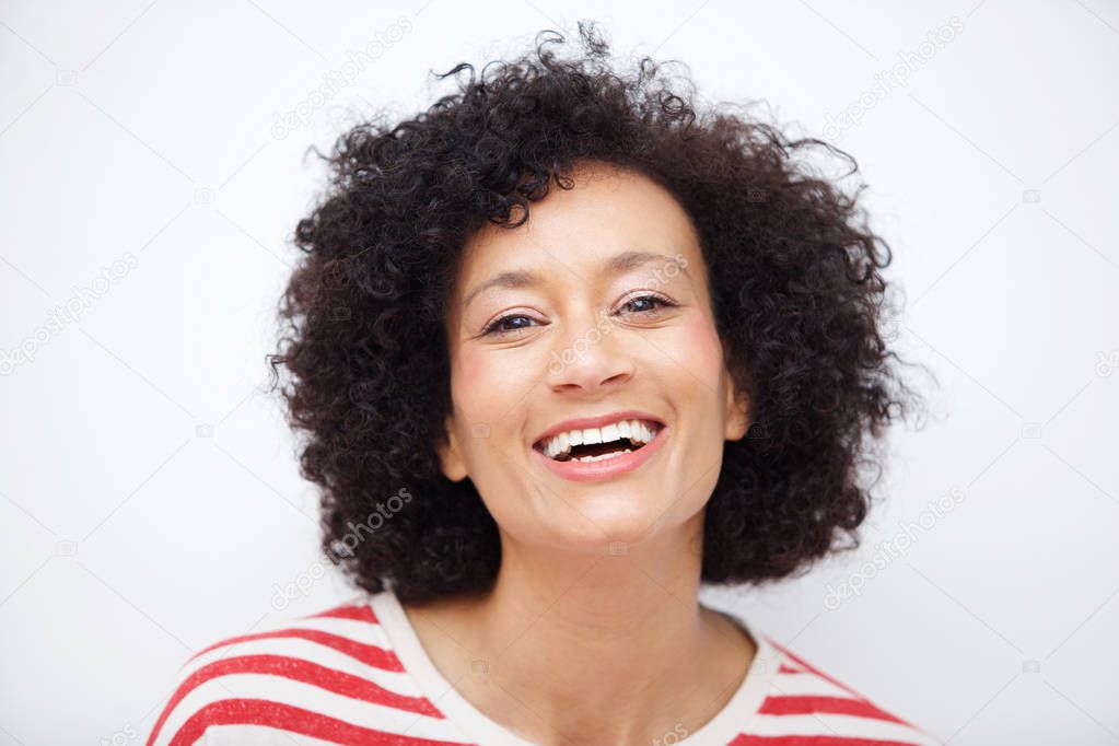 Close up front portrait of and older african american woman laughing against white background