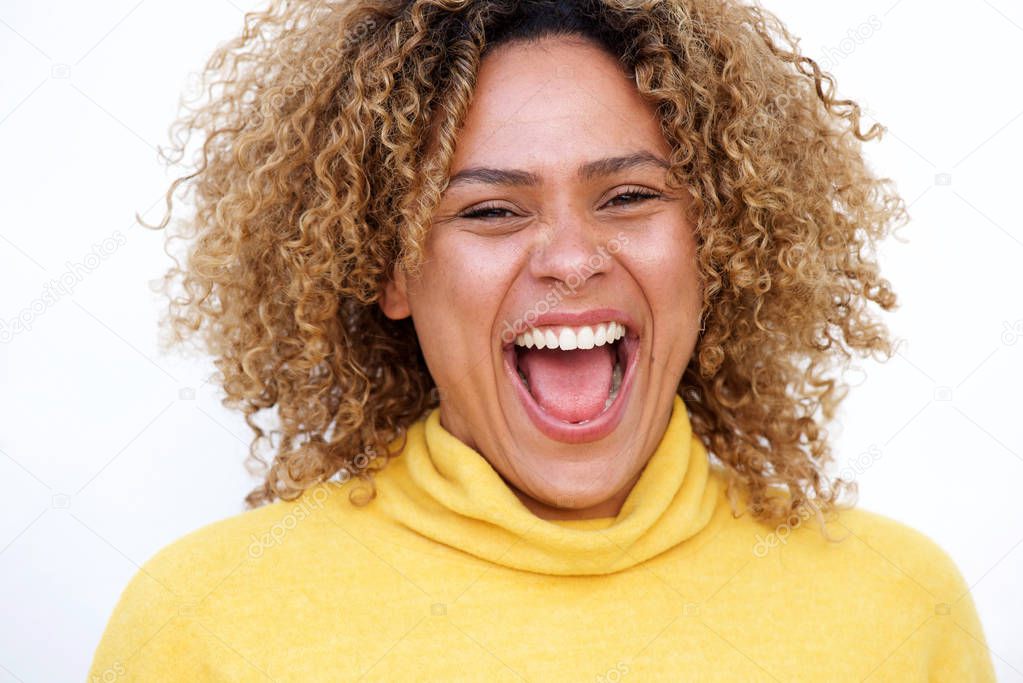 Close up horizontal portrait of young african american woman laughing against isolated white background