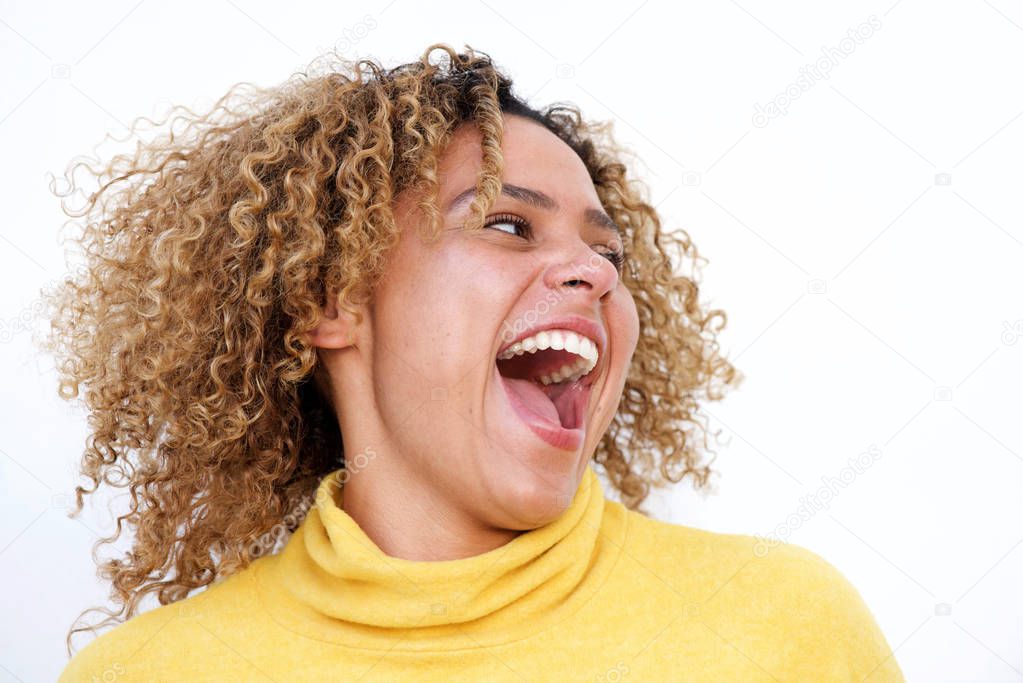 Close up portrait of happy young african american woman laughing against isolated white background