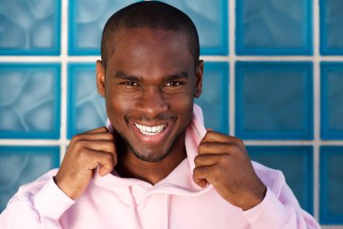 Kapüşonlu genç Afro-Amerikan adamla gülümseyen portresi kapatın