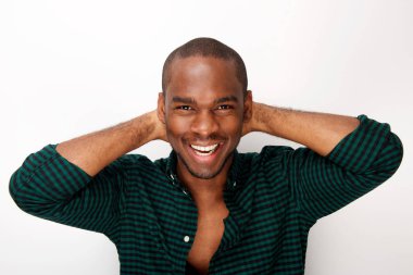 Close up portrait of young african american male fashion model smiling with hands behind head against isolated white background clipart