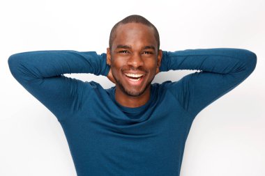 Portrait of cheerful young black man posing with hands behind head against white background