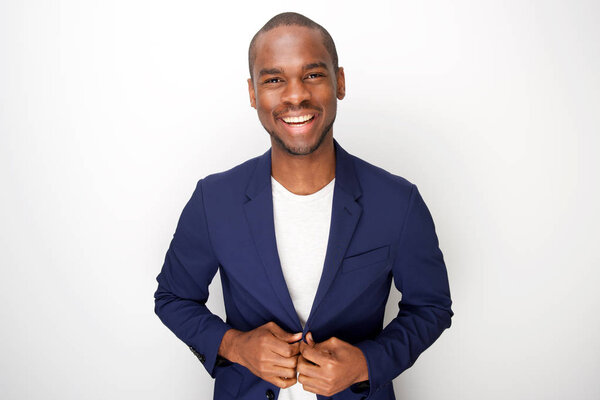 Portrait of stylish young black man in blazer jacket against white background