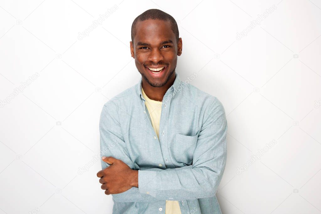 Portrait of smiling young african american man smiling with shirt by white background