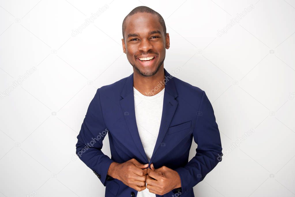 Portrait of stylish young black man in blazer jacket against white background