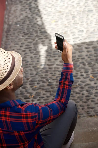 Portret Tyłu Młody Czarny Kapelusz Patrząc Telefon — Zdjęcie stockowe