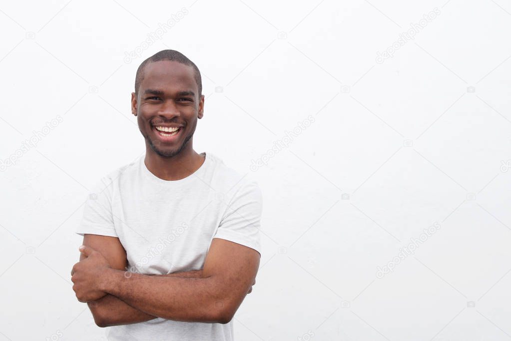 Portrait of handsome young african american man smiling with arms crossed against isolated white background