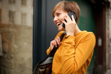 Cep telefonu ile konuşan mutlu genç kadın Portresi