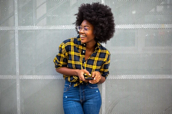 Портрет Счастливой Улыбающейся Молодой Черной Женщины Афроволосами Держащей Мобильный Телефон — стоковое фото