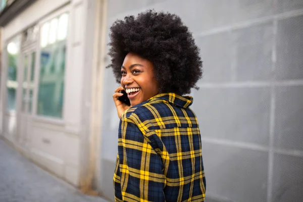 Portrait Laughing Young Black Woman Turning Talking Mobile Phone — Stock Photo, Image