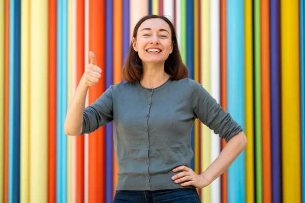 Portrait Older Woman Smiling Thumbs Hand Sign Colorful Background — Stockfoto