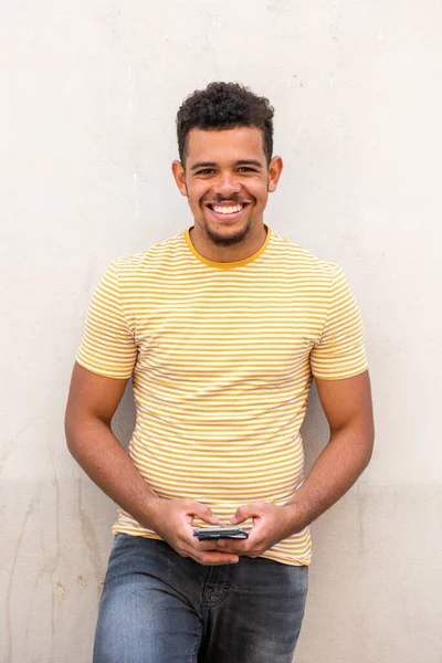 Portrait Smiling Young Mixed Race Man White Wall Holding Mobile — Stok Foto