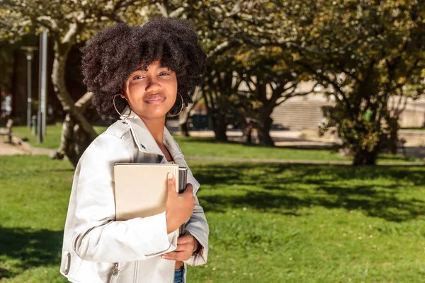 Young African American Woman Curly Hair Smiles Holding Several Books — Stock Photo, Image