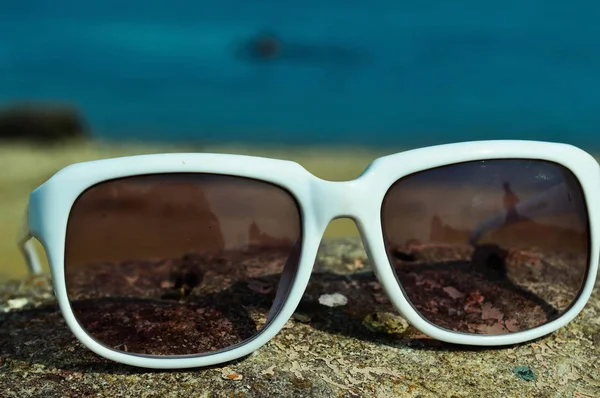 Sonnenbrille mit weißem Rand am Strand im Sommer am Meer — Stockfoto