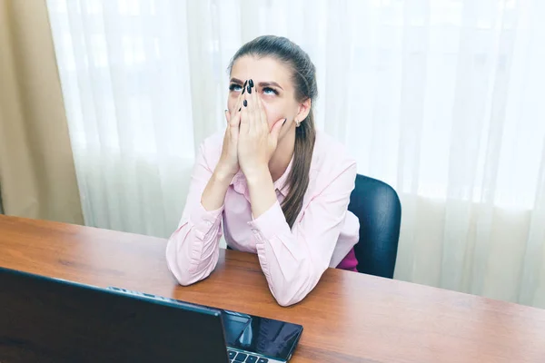 Young businesswoman is experiencing stress in the workplace. Headache from overload in the workplace.