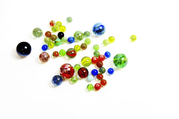 Top-view-of-various-molcolored-glass-balls-on-white-background — стоковое фото