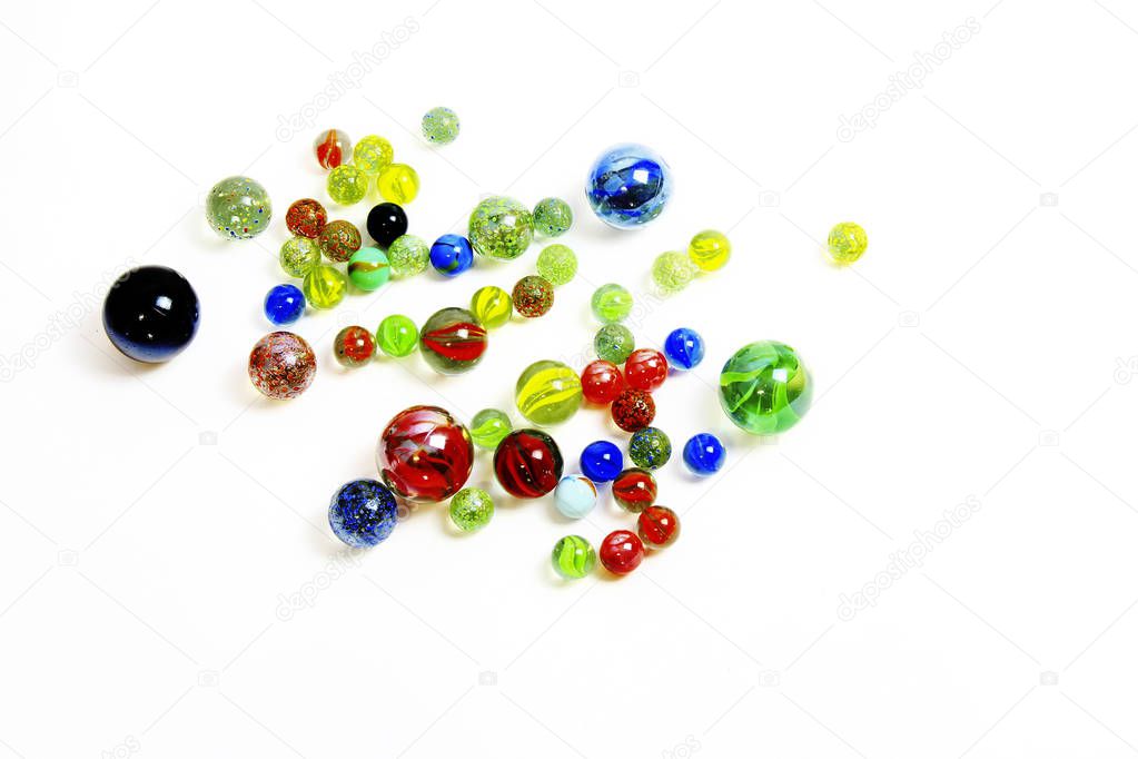 Top-view-of-various-multicolored-glass-balls-on-white-background