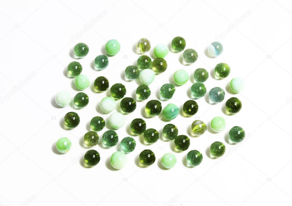 Background-with-various-green-glass-balls-on-white