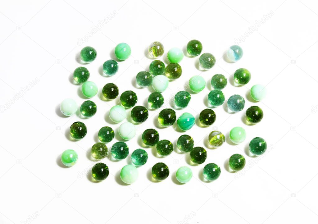 Background with various green glass balls on whit
