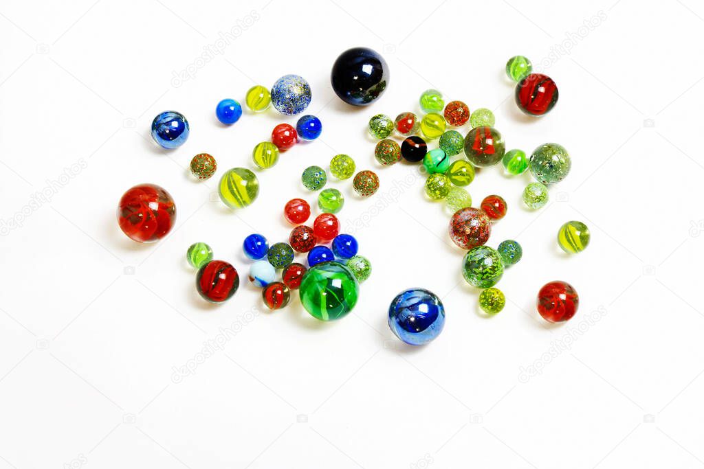Background of various multicolored glass balls on whit
